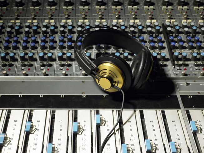 Image of a mixing board & headphones